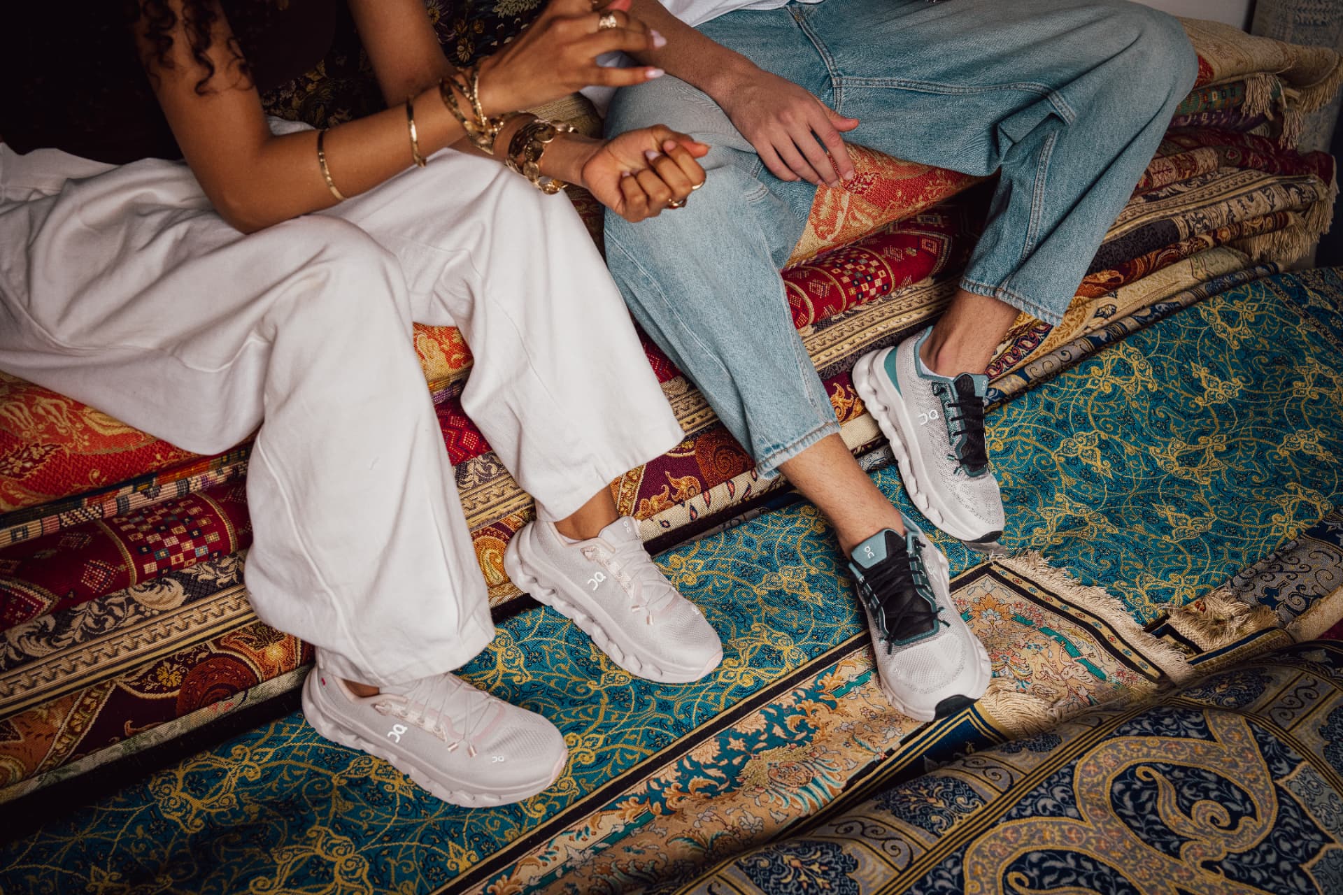 Close-up of sneakers on layered patterned rugs