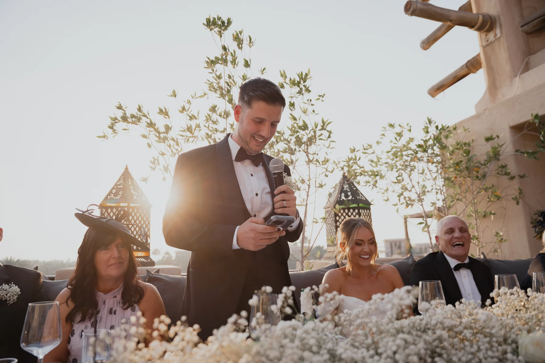 Groom giving a speech at sunset