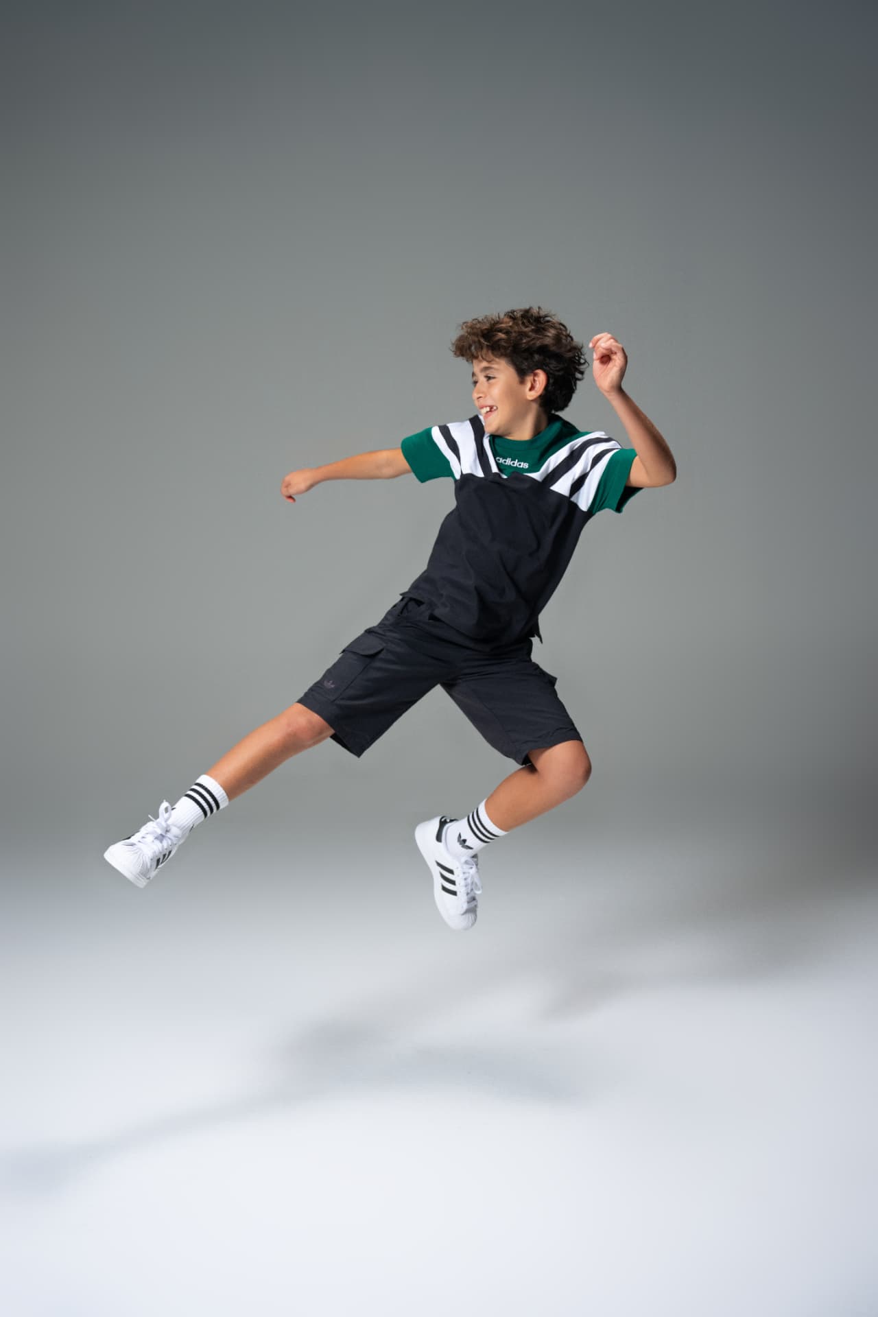 Boy mid-jump in an Adidas football kit