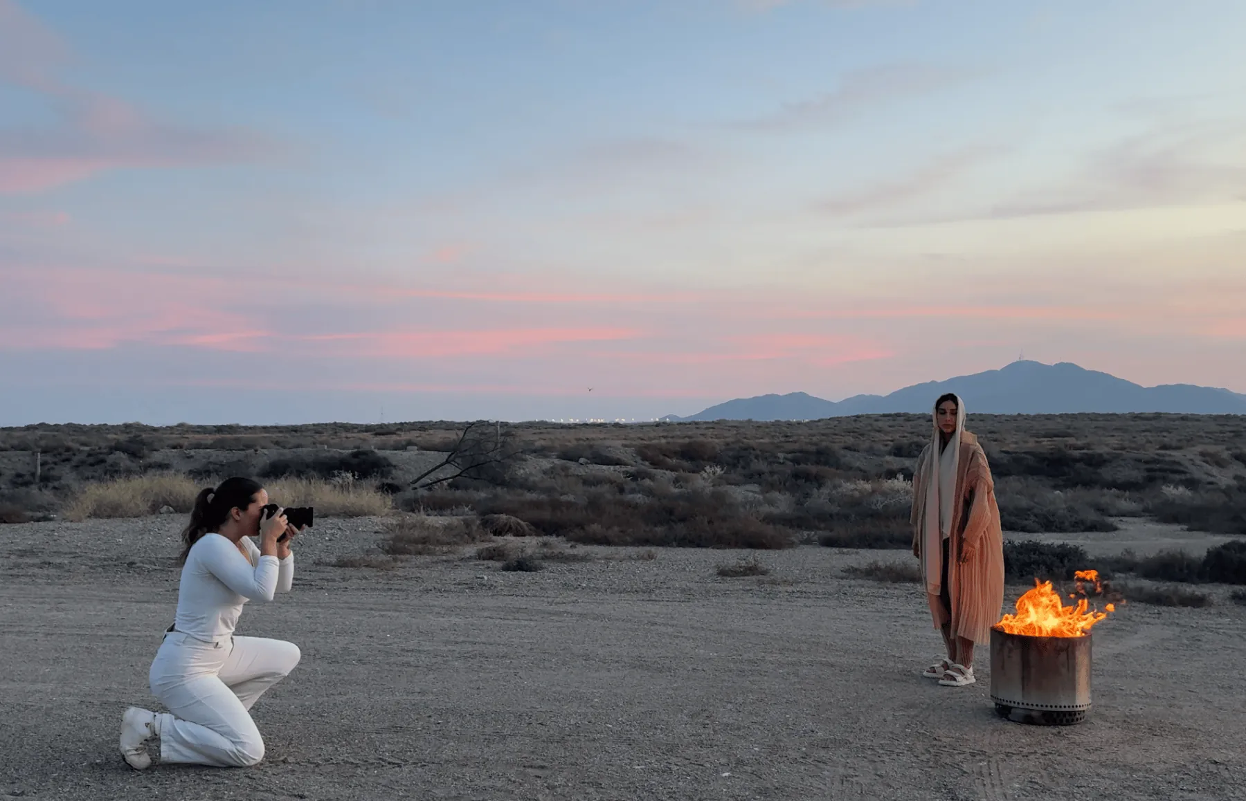 Emma photographing in the desert at dusk