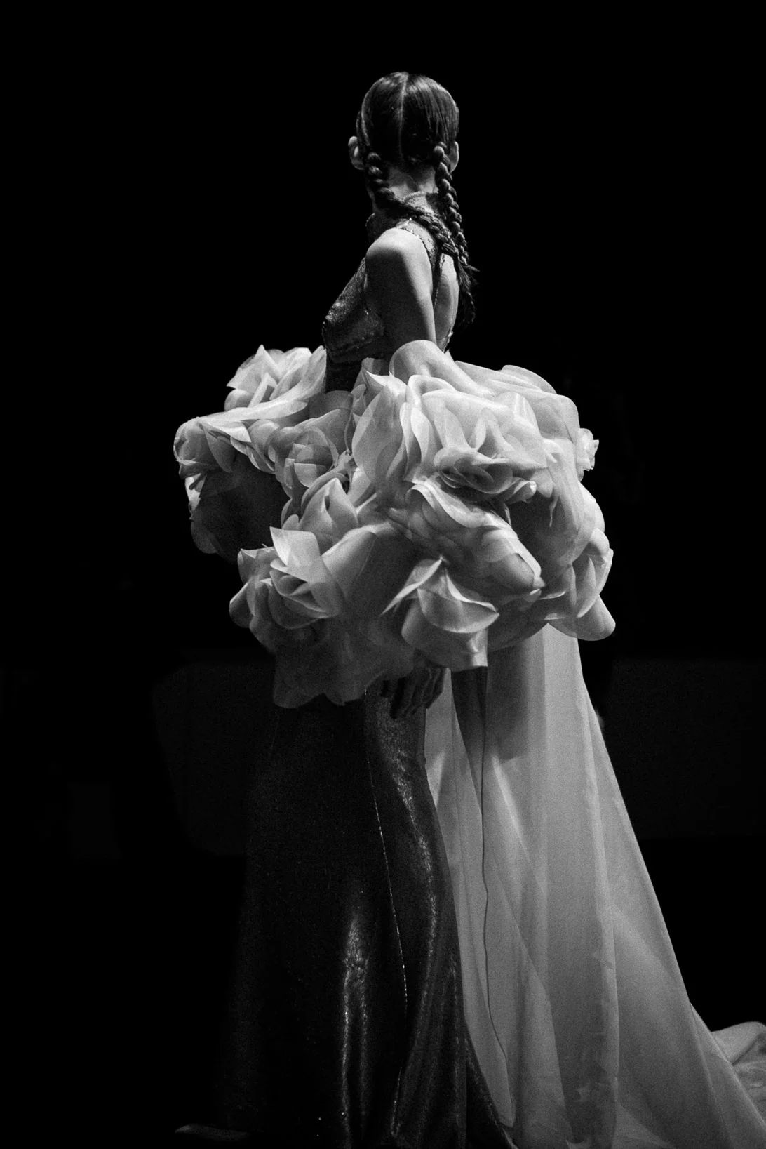 Bride in a sculpted gown against black