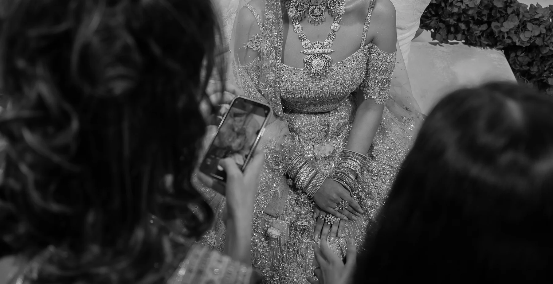 Guests gathered around the bride, black and white