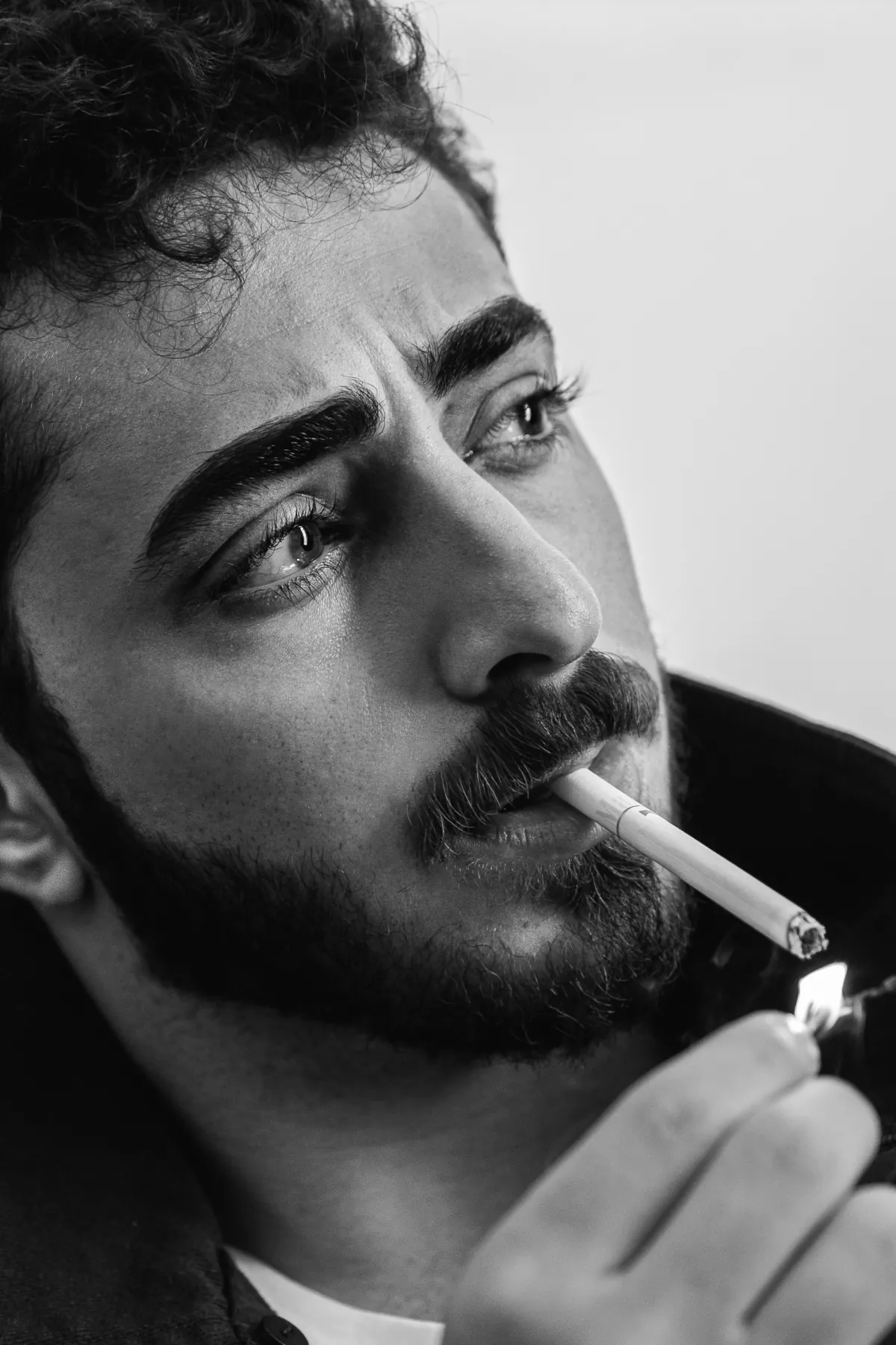 Man lighting a cigarette, black and white