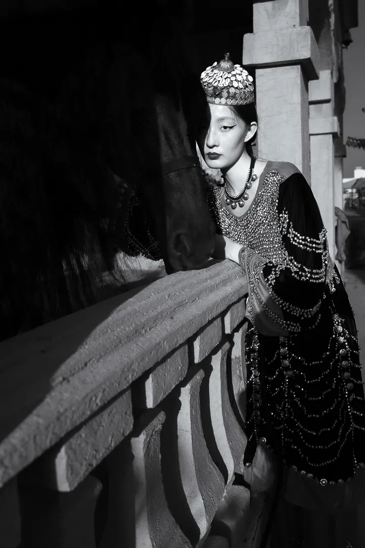 Black and white editorial in a crown and gown