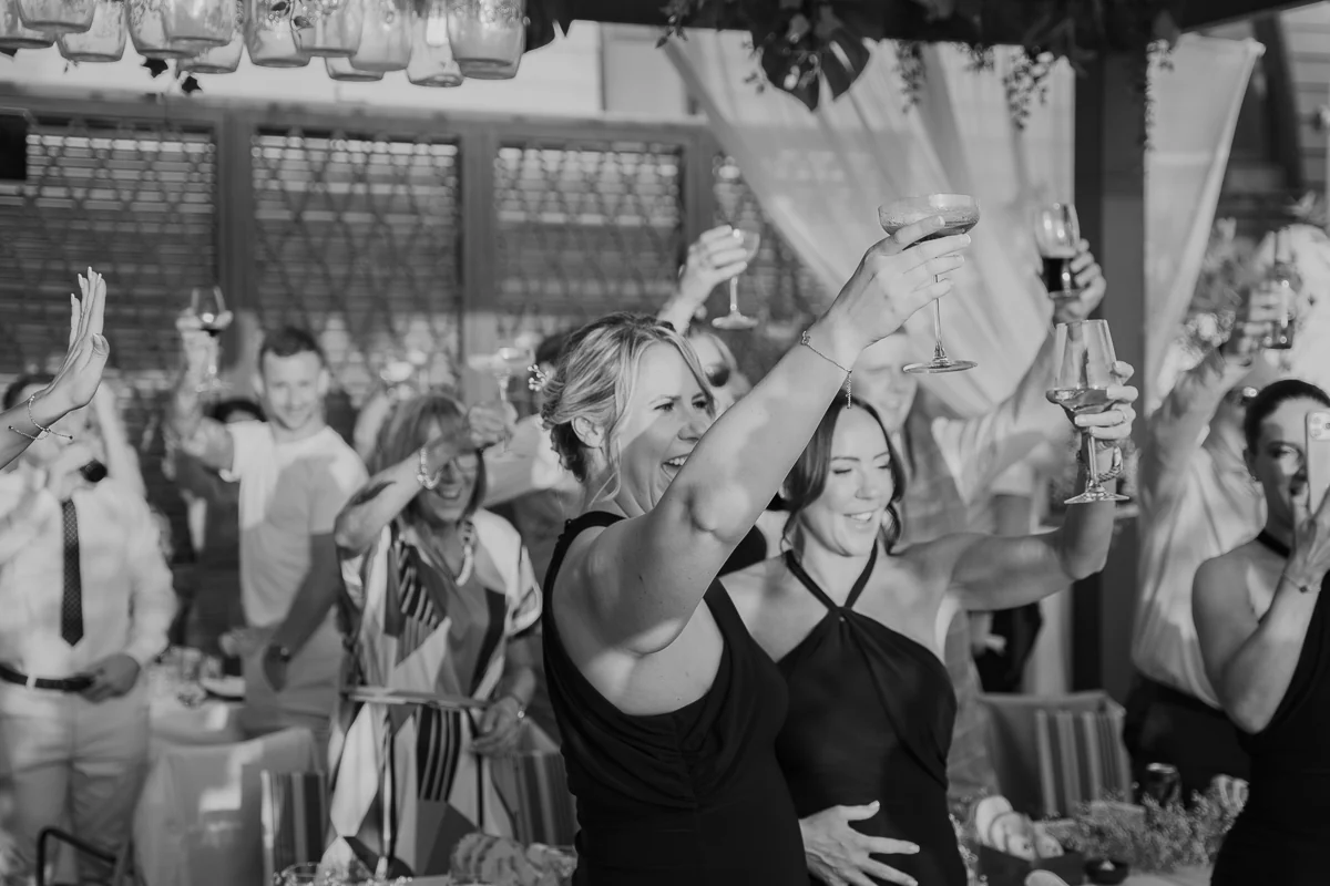 Guests dancing at the reception, black and white