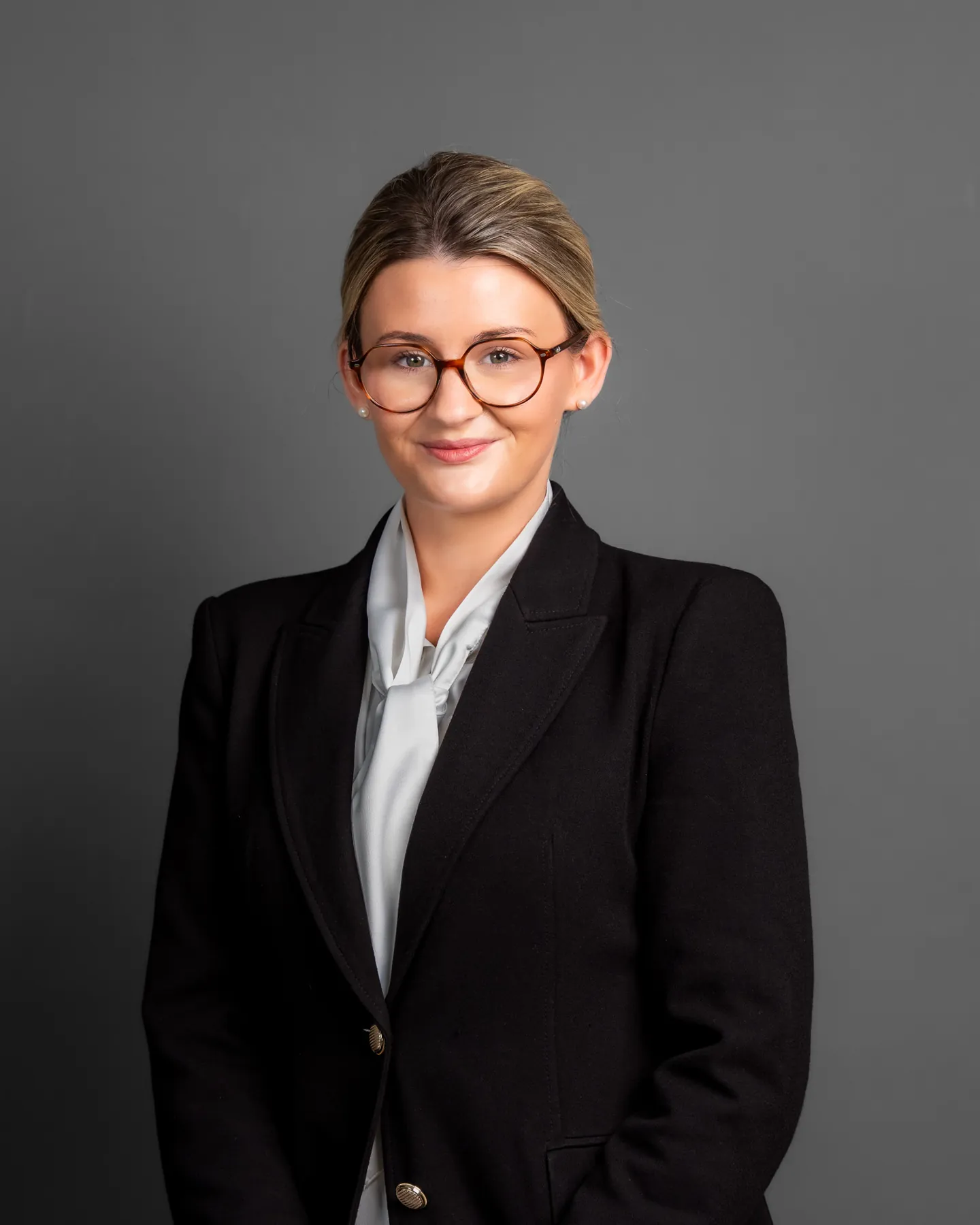 Professional portrait of a woman wearing glasses