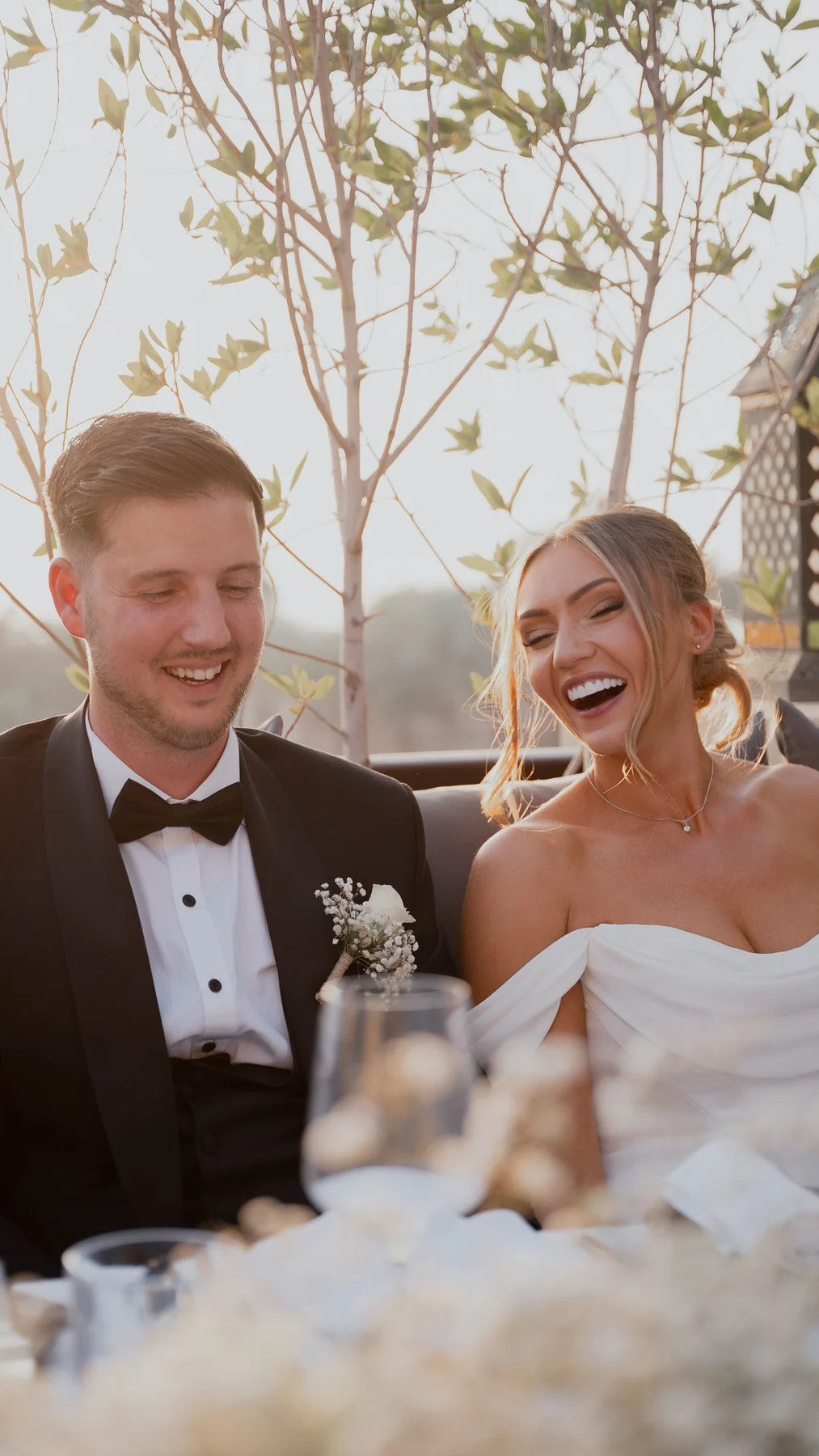 Bride and groom laughing at the table