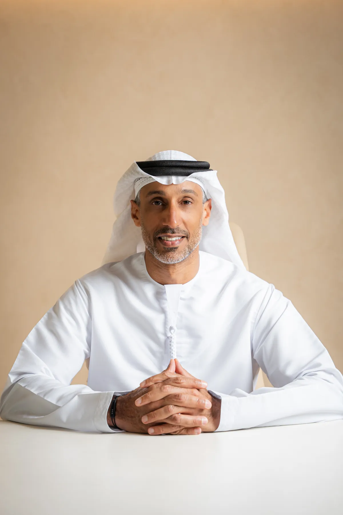 Emirati executive seated at a white desk