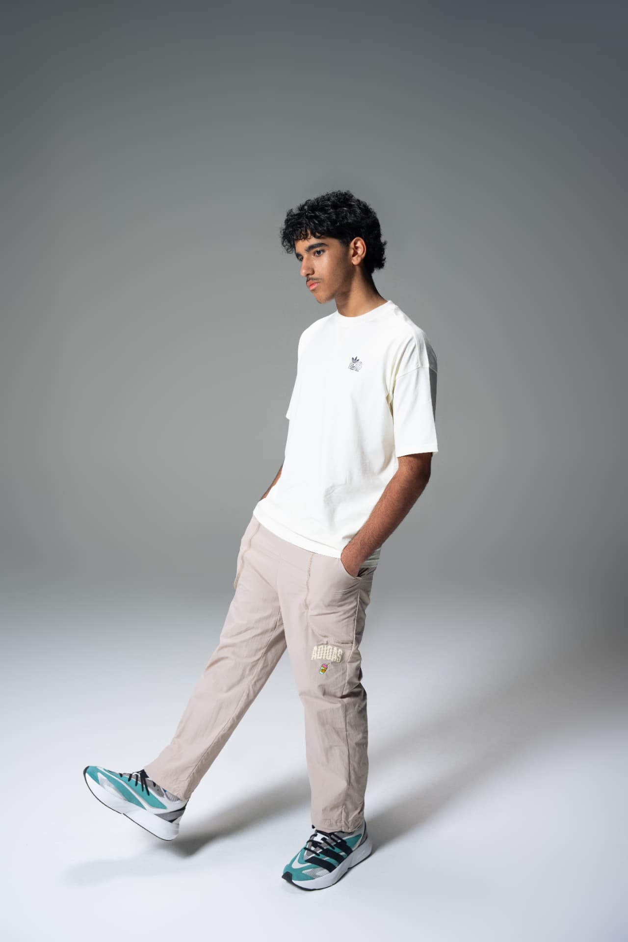 Young man in a white Adidas tee and cargo trousers